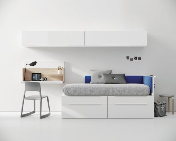 Compact youth bedroom including a wall desk